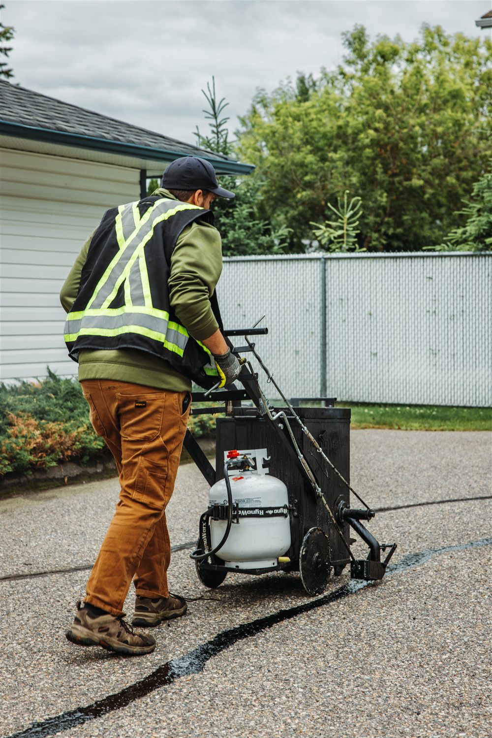 Hot rubber crack sealing applied to asphalt by Laser Pavement Solutions