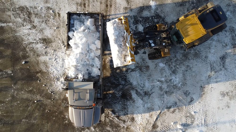 Commercial snow removal equipment clearing a parking lot in Prince George, BC